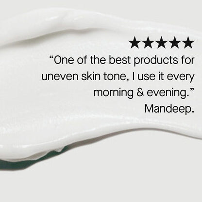 An image shows white cream smeared across a gray background. On top of the cream smear, there's a five-star rating and a testimonial reading, "One of the best products for hyperpigmentation; I use it every morning & evening." Followed by the name "Mandeep". The product depicted is Environ Focus Care Radiance+ Intense C-Boost Mela-Even Cream from Environ.