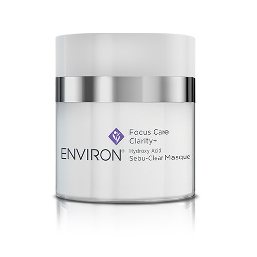 A white jar of Environ Clarity+ Hydroxy Acid Sebu-Clear Masque with a silver lid. The product label includes its name, highlighting the presence of Salicylic Acid and the Environ logo.