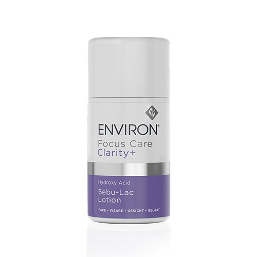 A white cylindrical cosmetic bottle labeled "Environ Clarity+ Hydroxy Acid Sebu-LAC Lotion." The label, featuring text in English, French, German, and Dutch, notes it is for face use. The lower portion of the Environ Clarity+ Hydroxy Acid Sebu-LAC Lotion bottle is accented with a purple band.