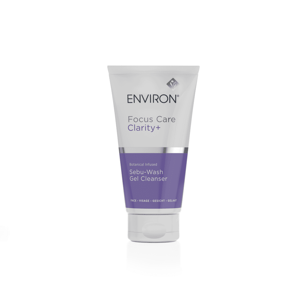 A white tube with a gray cap labeled "Environ Focus Care Clarity+ Botanical Infused Sebu-Wash Gel Cleanser." The lower part of the tube is purple and includes additional product details. This mattifying foaming face wash is botanical-infused and anti-bacterial, making it ideal for face washing and addressing problematic skin.