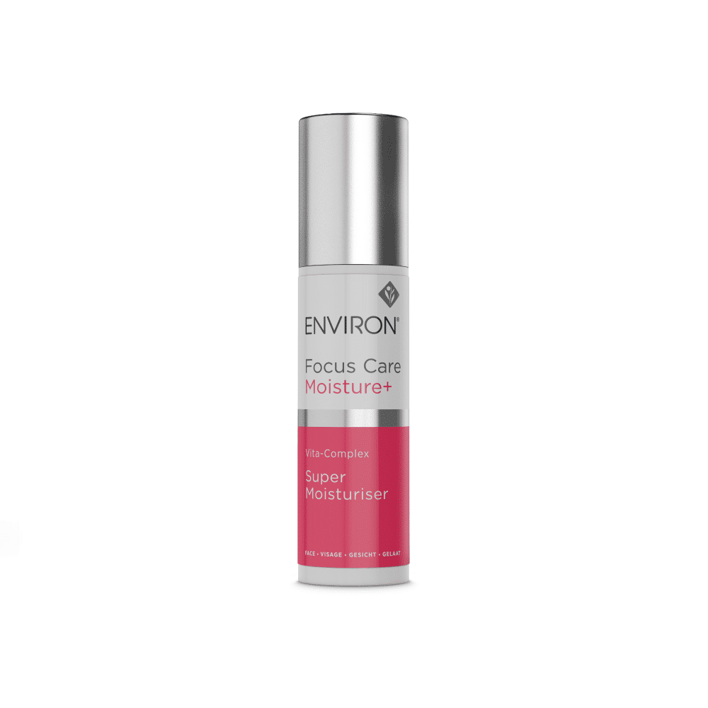 A white and pink cylindrical bottle of Environ Focus Care Moisture+ Vita-Complex Super Moisturiser - New Formula with a metallic silver cap. The product label showcases the brand, Environ, product name, and additional information in smaller text, promising intense hydration for a youthful glow.