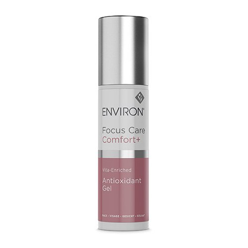 A cylindrical bottle labeled "Environ Focus Care Comfort+ Antioxidant Gel" with a silver cap and a pink and white body. Environ Focus Care Comfort+ Antioxidant Gel, by Environ, is vita-enriched and perfect for sensitive skin. This product is intended for face use to soothe inflammation.